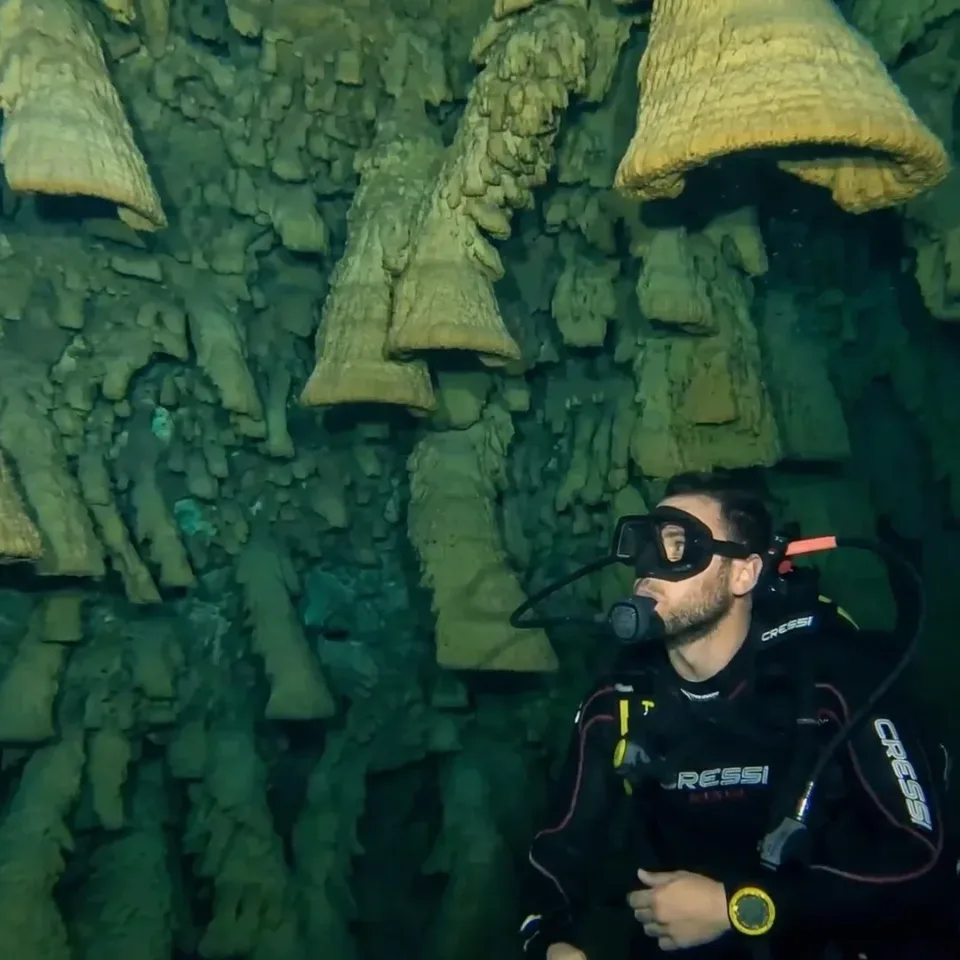 Diver beside the Hell's Bells formations in Cenote Zapote