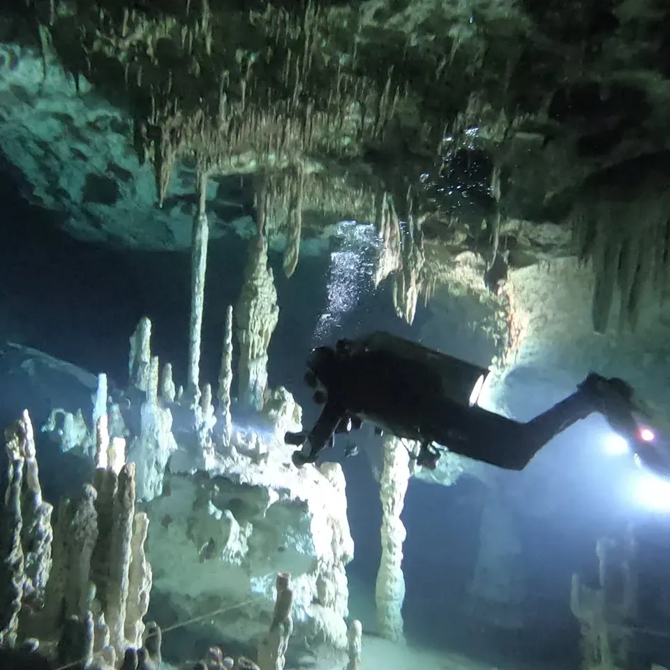 Diver among stalactites and stalagmites inside Cenote Dream Gate