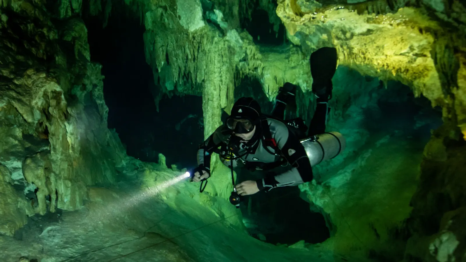 Stalactites and stalagmites inside Cenote Dream Gate